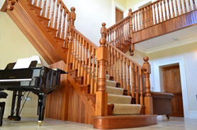 Bifurcated cut string khaya staircase with offset newel posts. Doors and architraves also by Blackhill (Location: Northern Ireland)